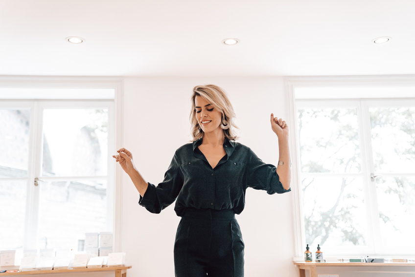 Happy young lady dancing in modern studio